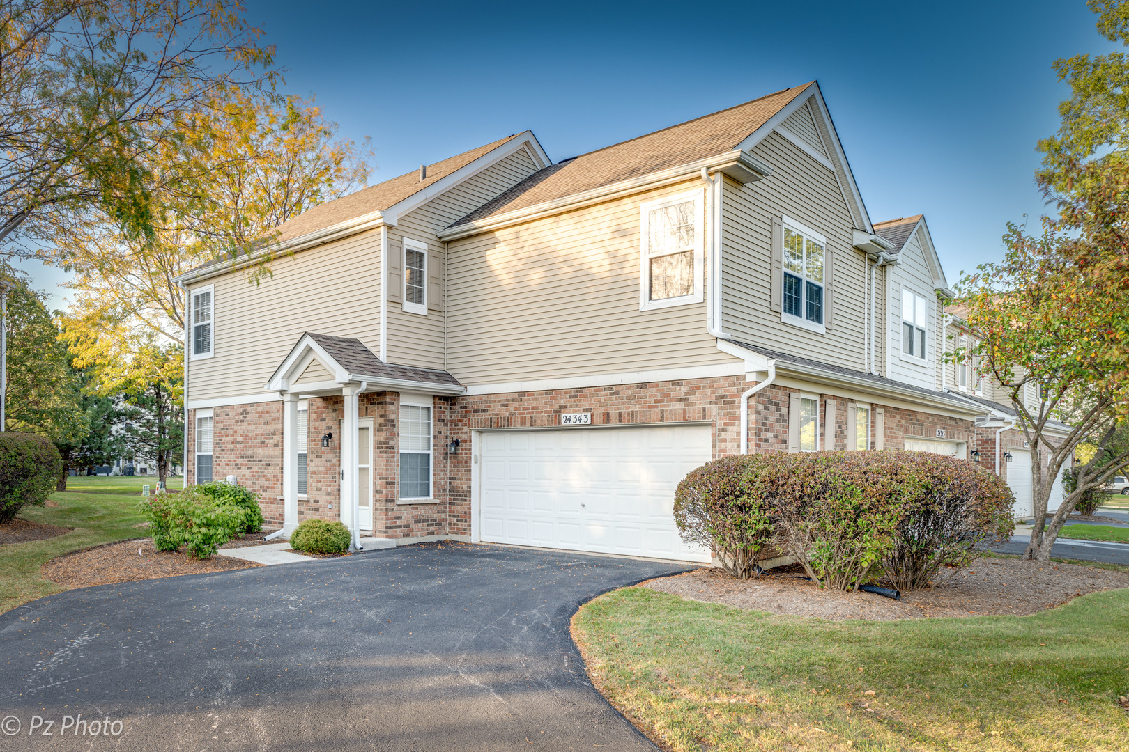 a front view of a house with a yard and garage