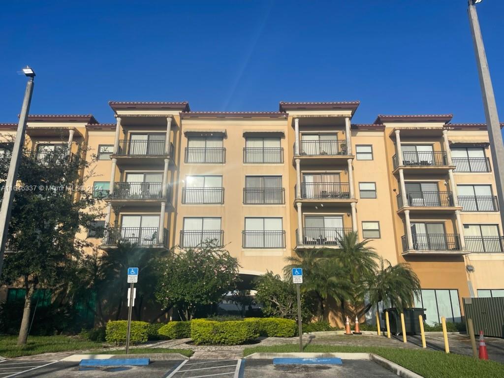 a front view of a residential apartment building with a yard