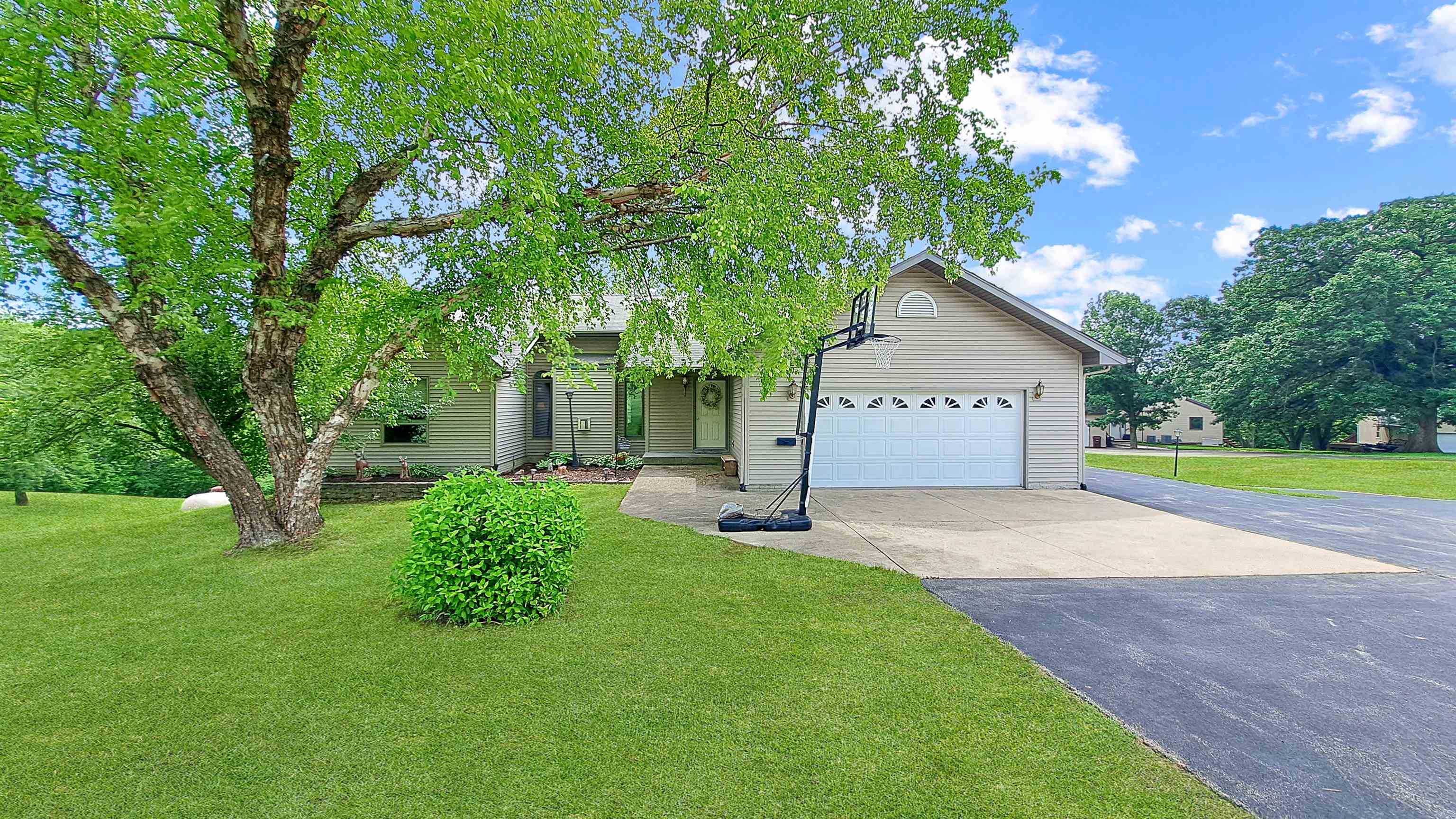 a view of backyard of house with green space