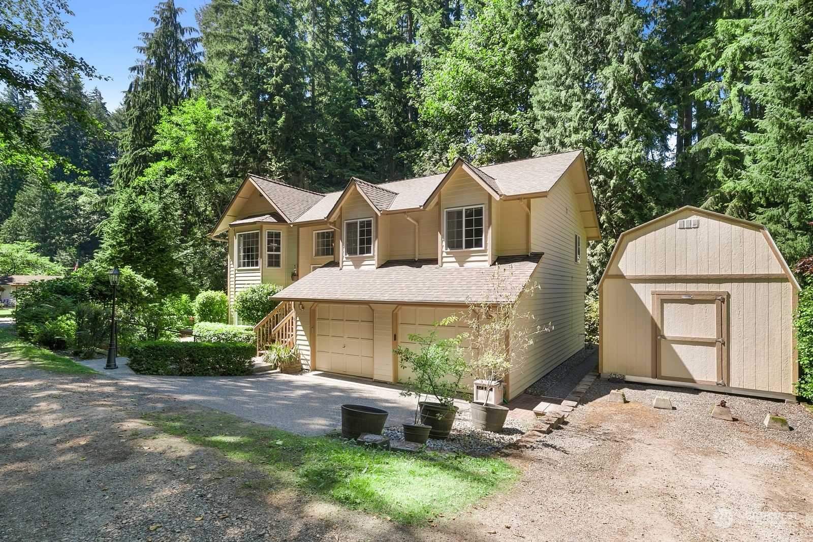 a front view of a house with a garden