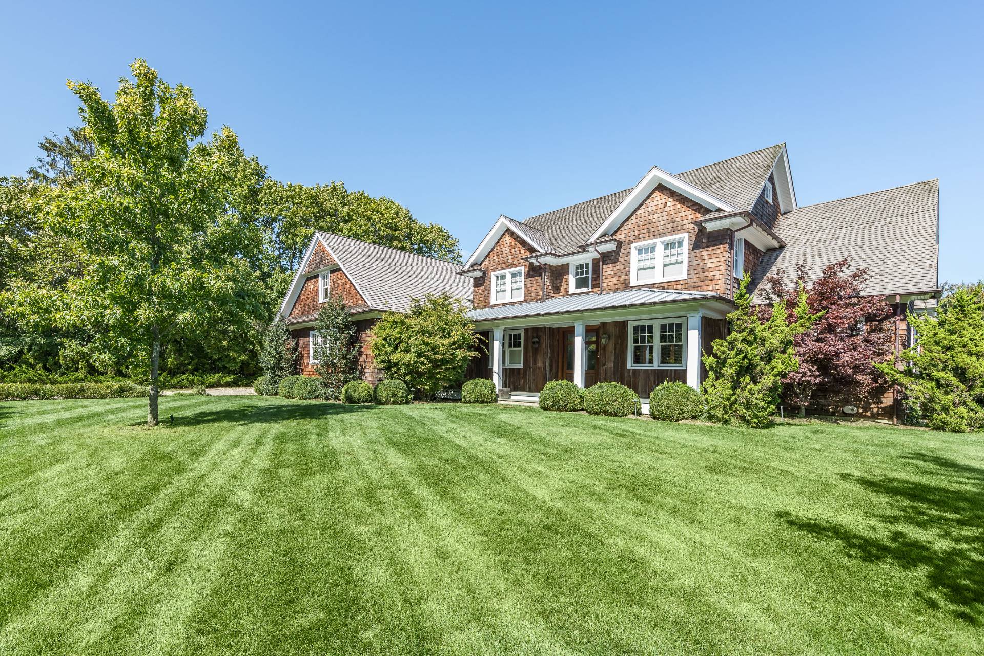 a front view of house with yard and green space