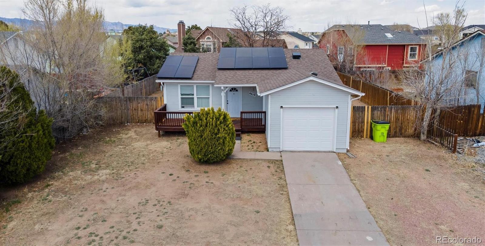 a view of a house with a yard and a garage