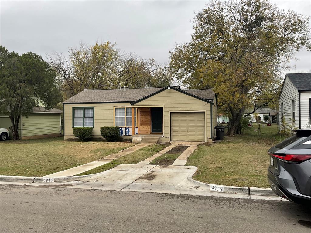 a view of a house with a yard and garage