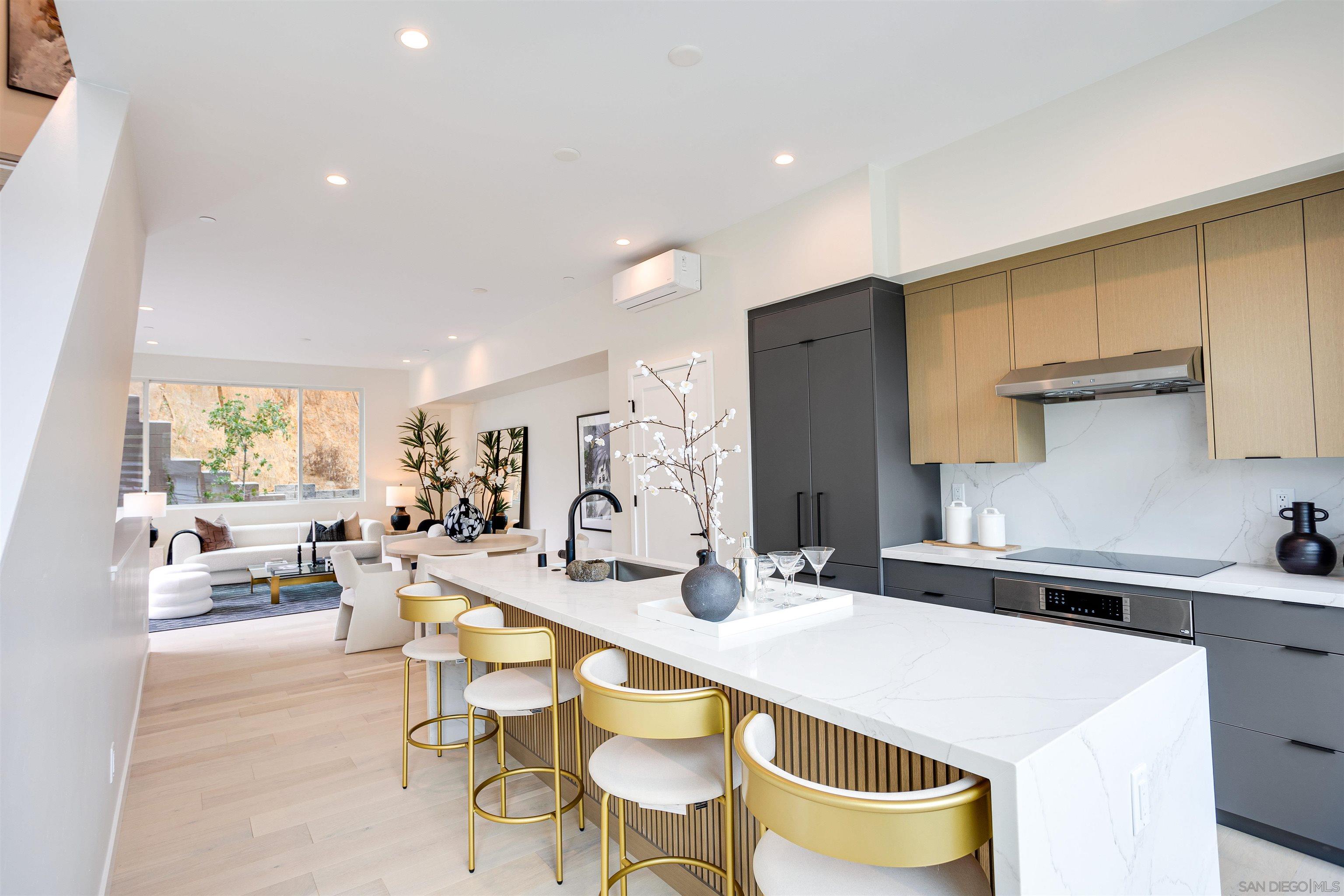 a large kitchen with a table and chairs