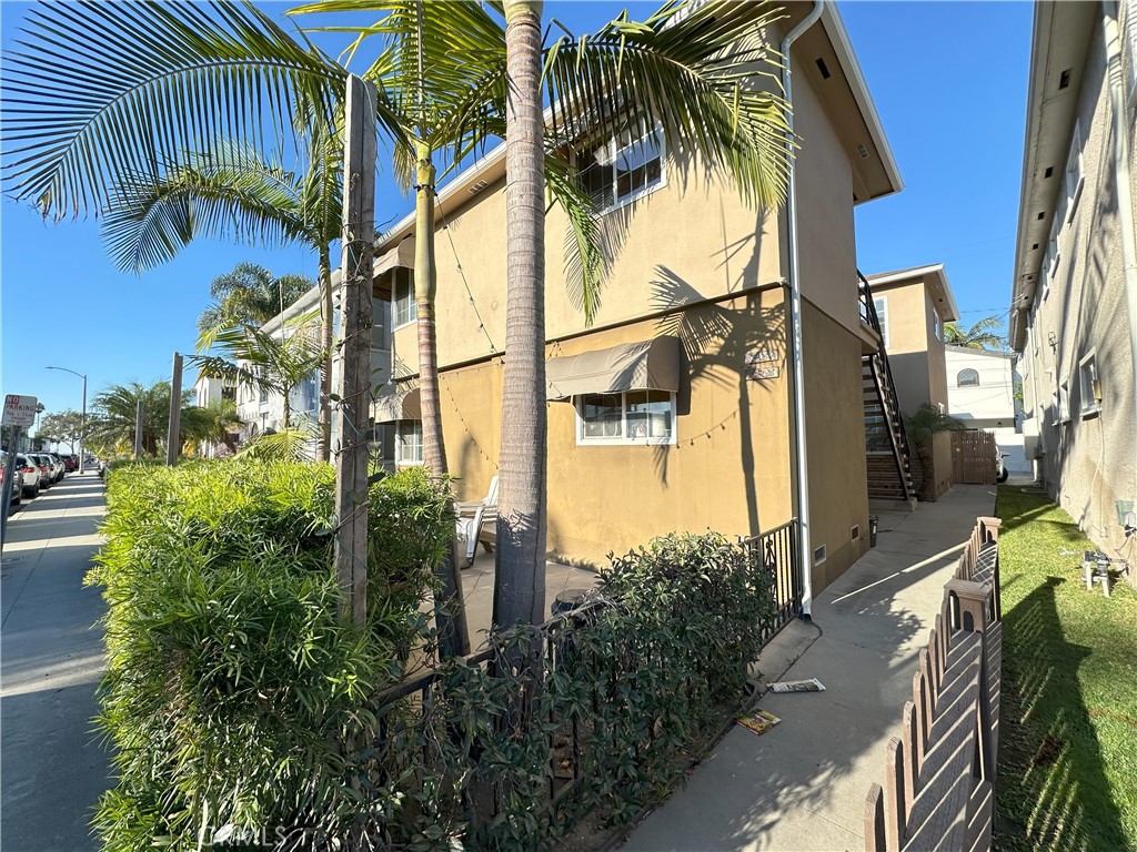 a view of a palm trees front of house