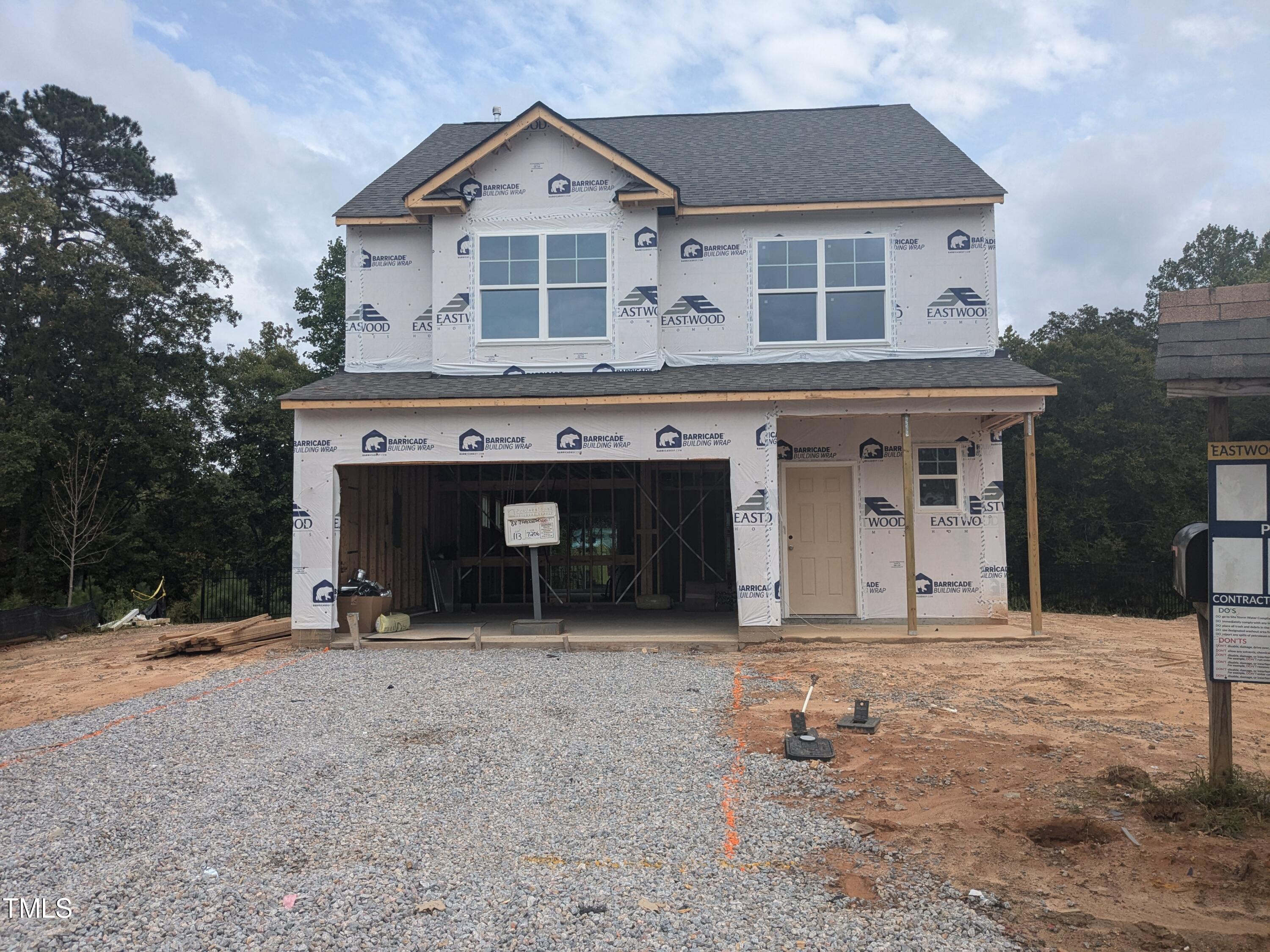 a view of a house with a yard and garage