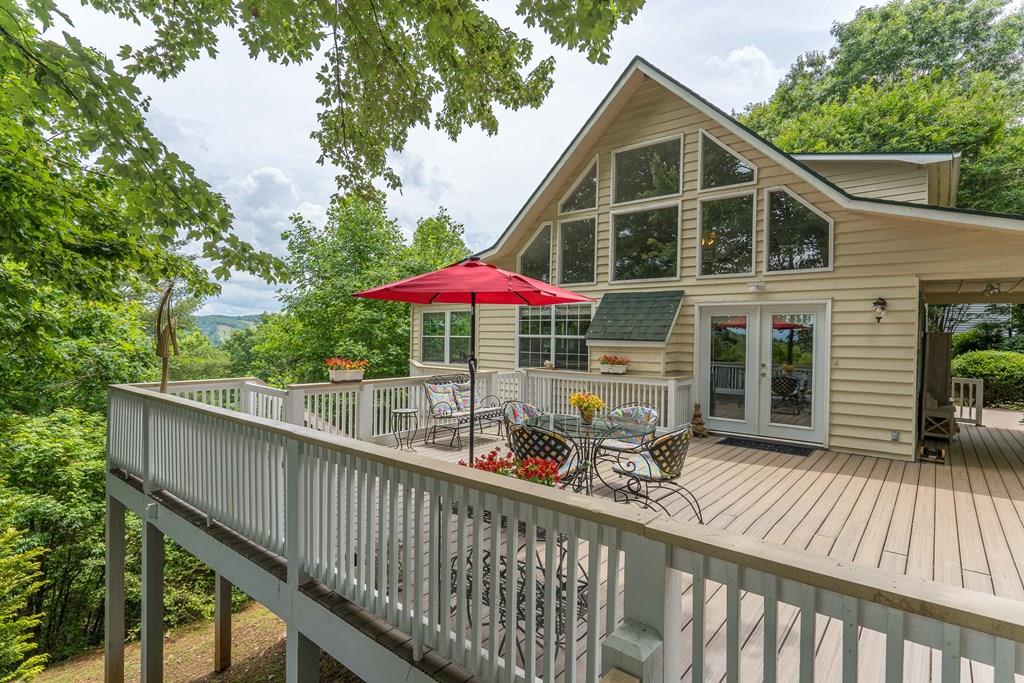 a front view of a house with patio and wooden deck