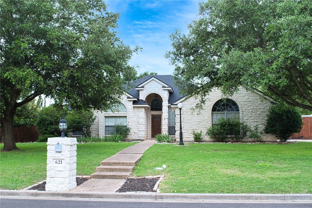 a front view of a house with a yard