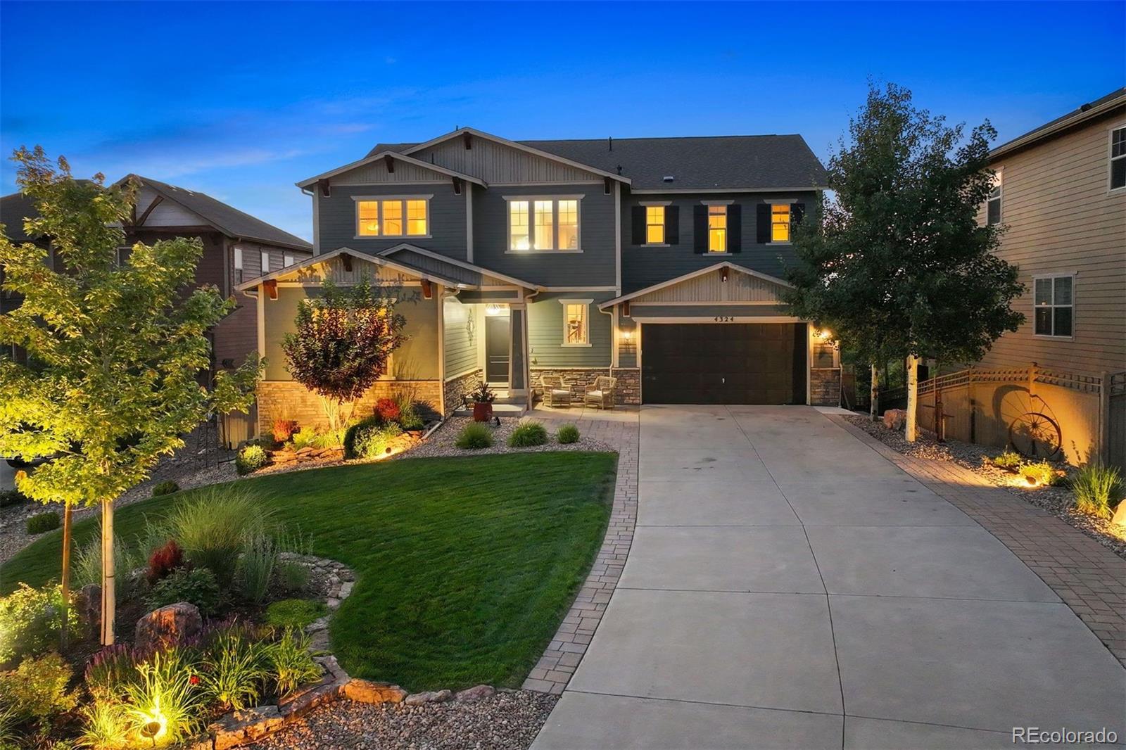 a front view of a house with a garden and yard