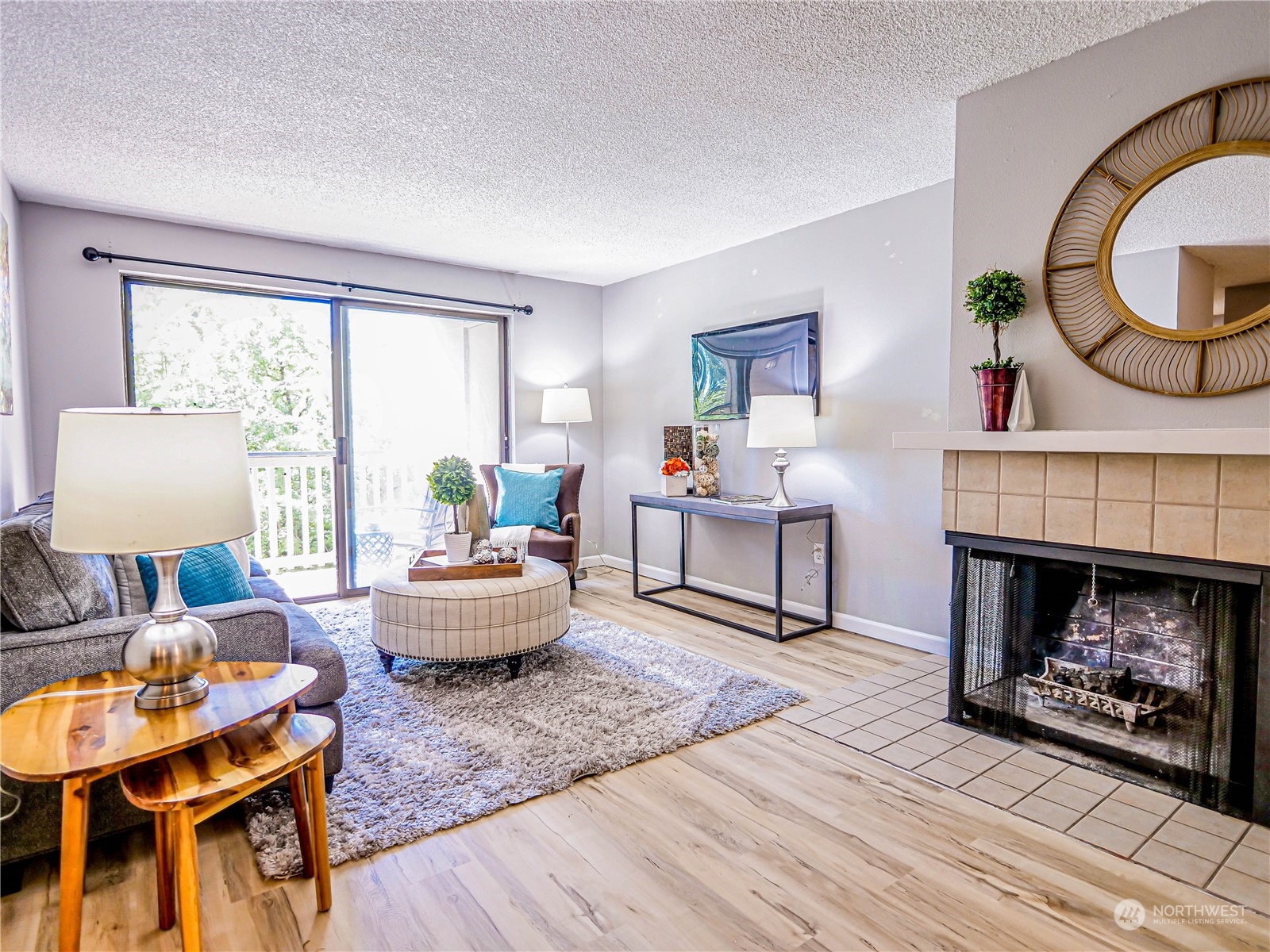 a living room with furniture a fireplace and a large window