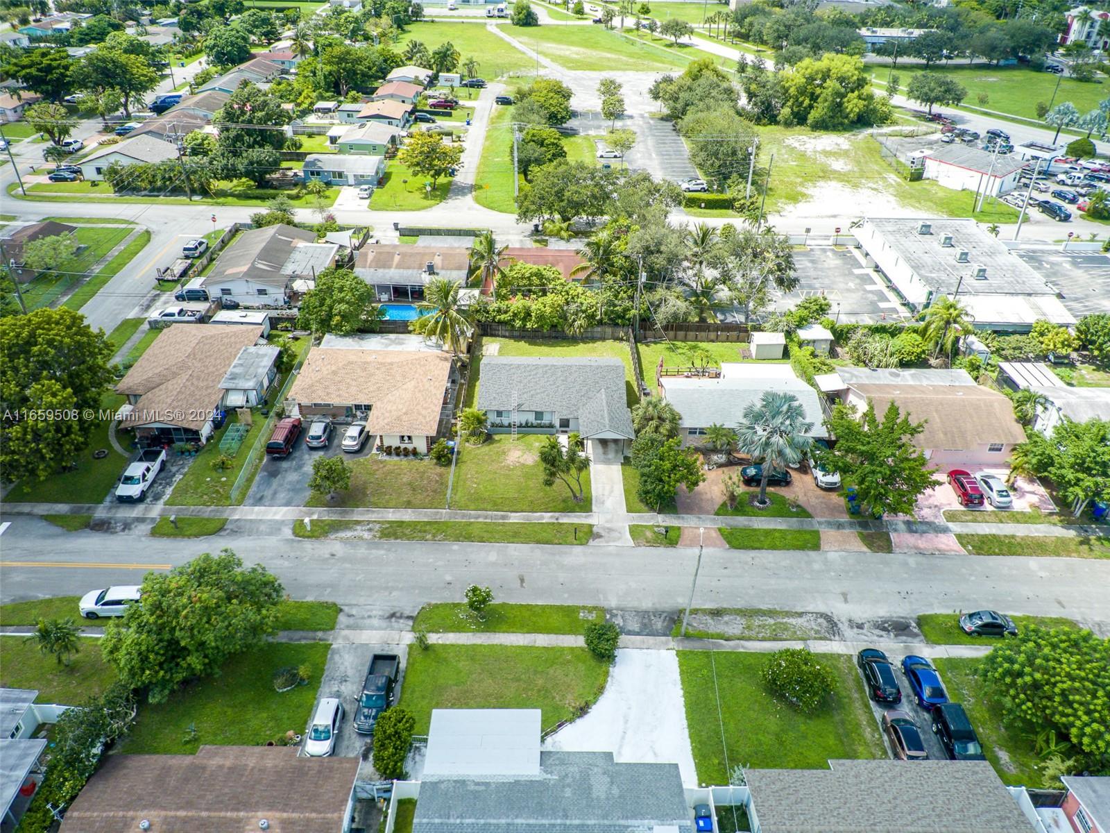 an aerial view of residential houses with outdoor space and street view