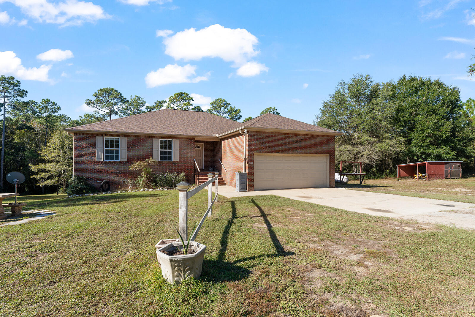 a view of a house with backyard and a patio