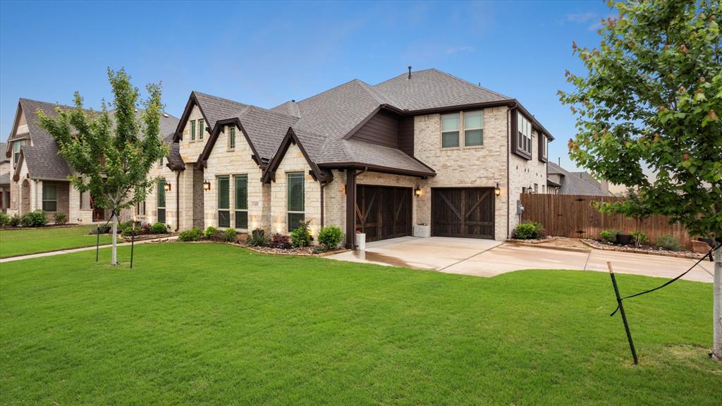 a front view of a house with a yard and porch