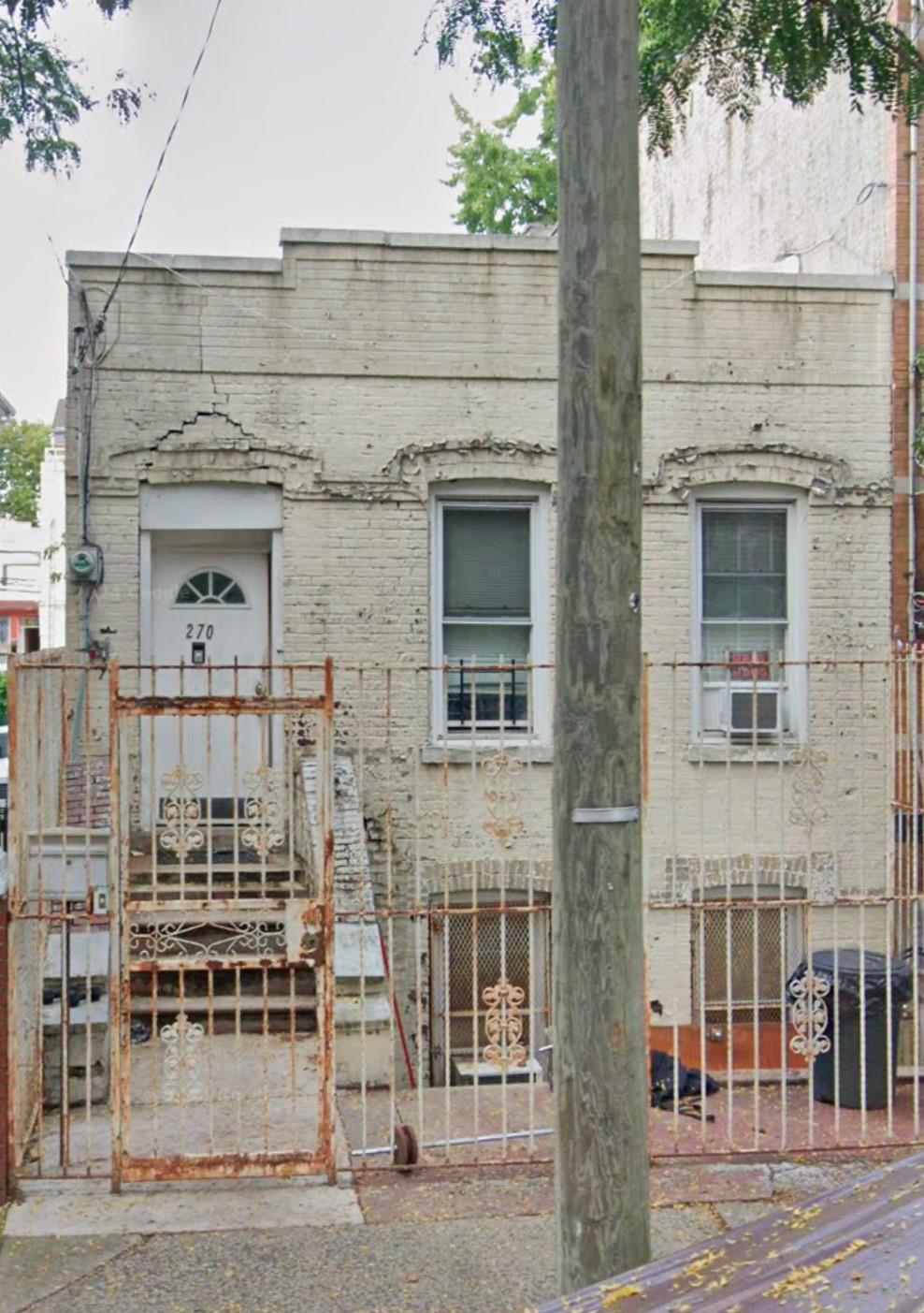 a view of a brick house with large windows