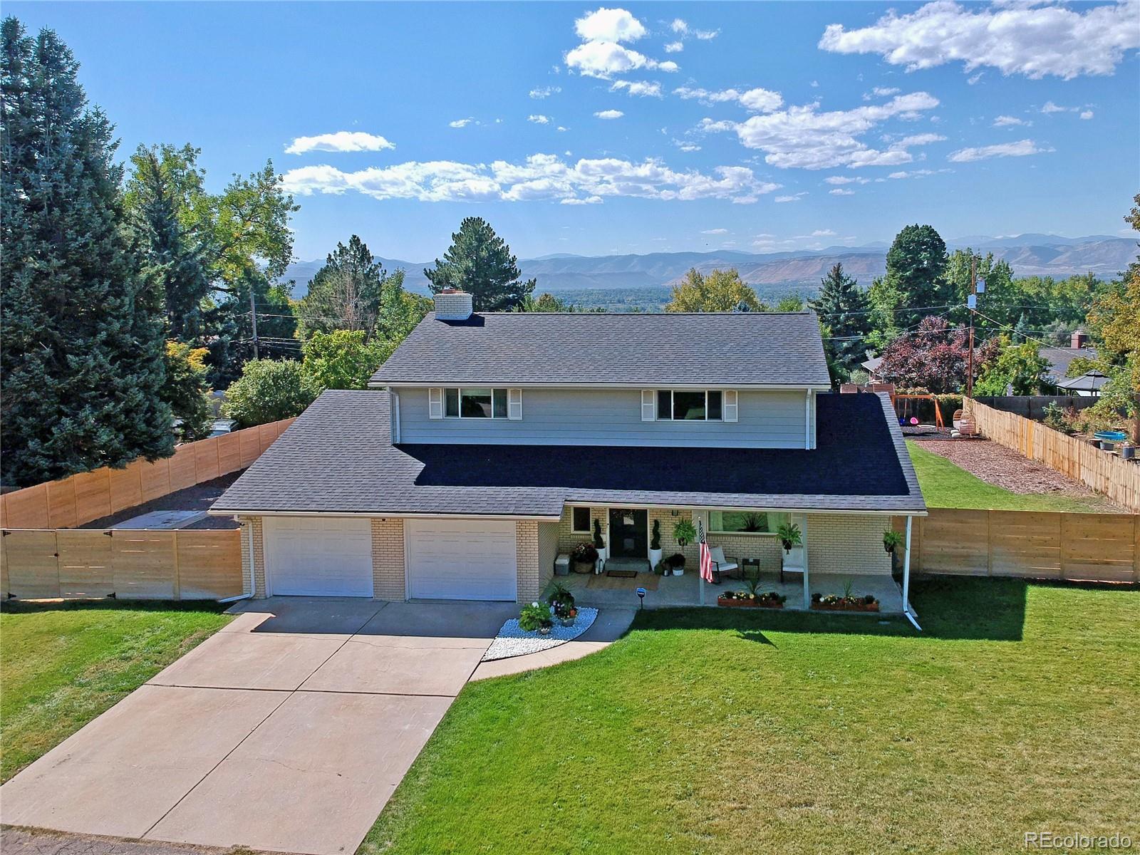 a front view of a house with a garden and yard