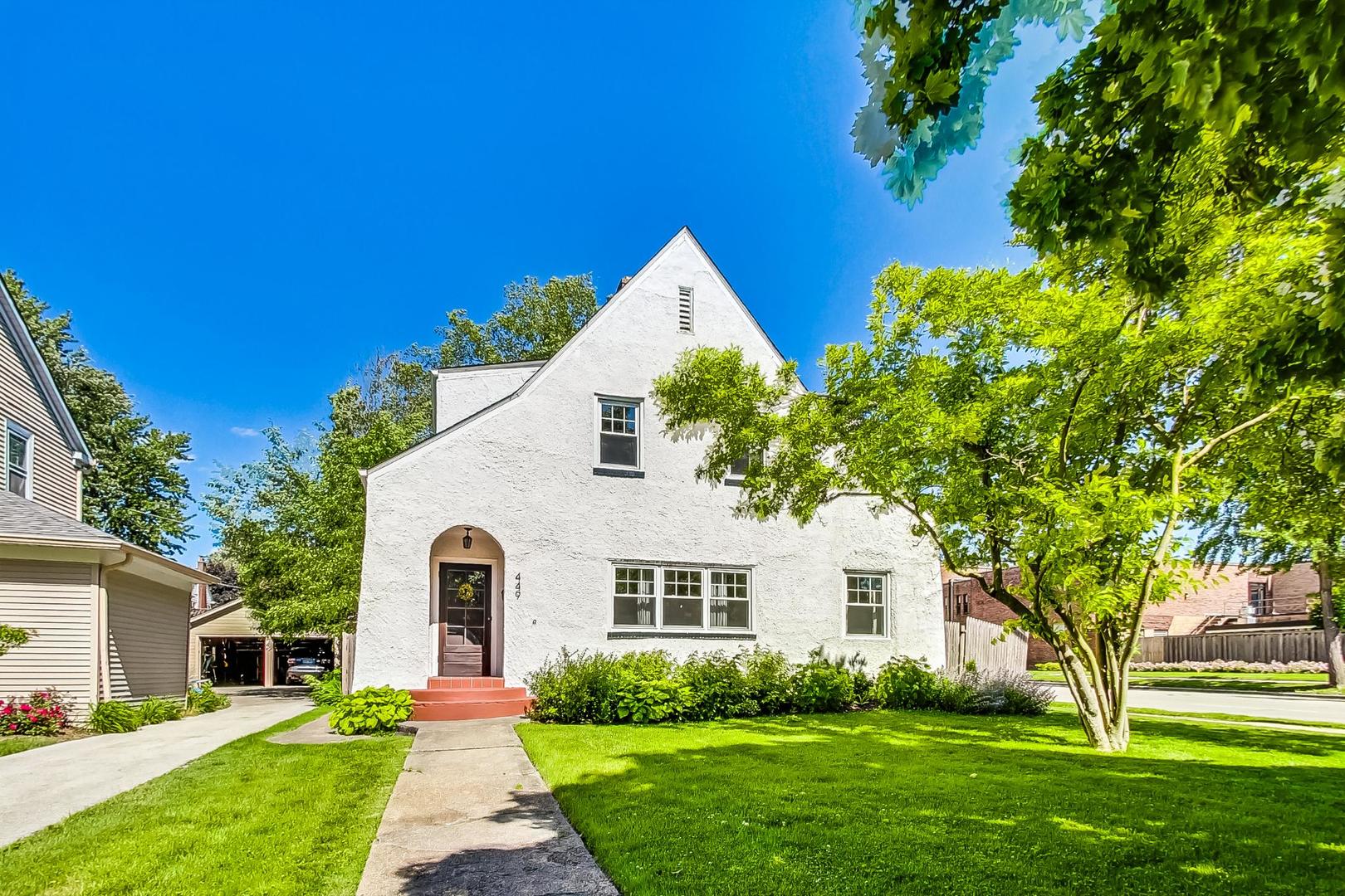 a front view of house with yard and green space