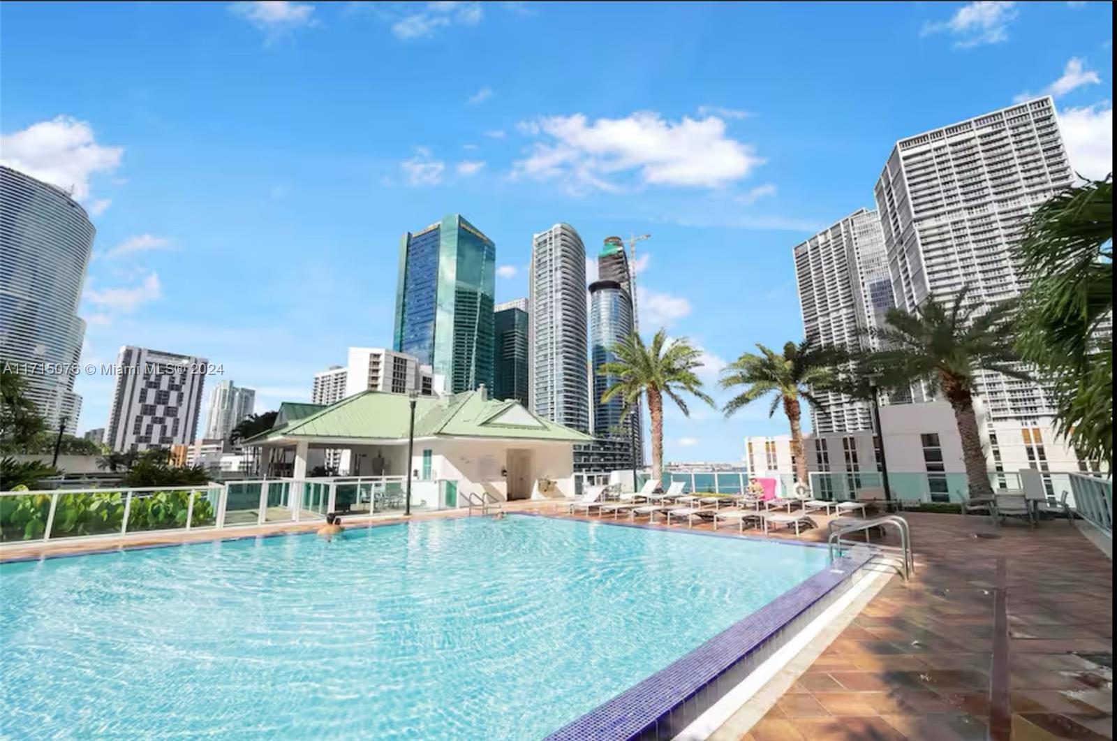 a view of a swimming pool with outdoor seating