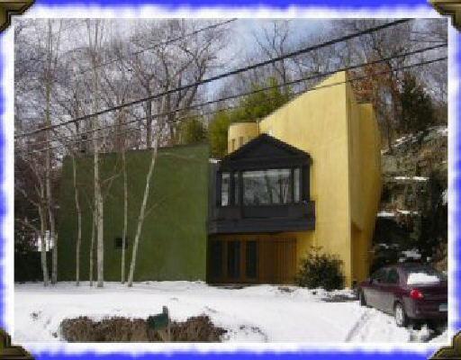 a view of a brick house with a small yard