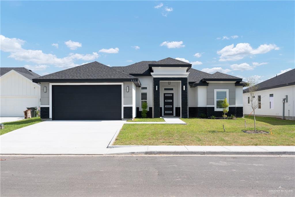 a front view of a house with a yard and garage