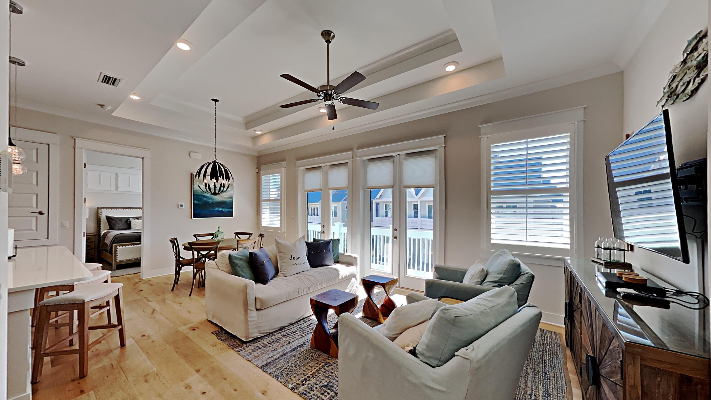 a living room with furniture ceiling fan and a window