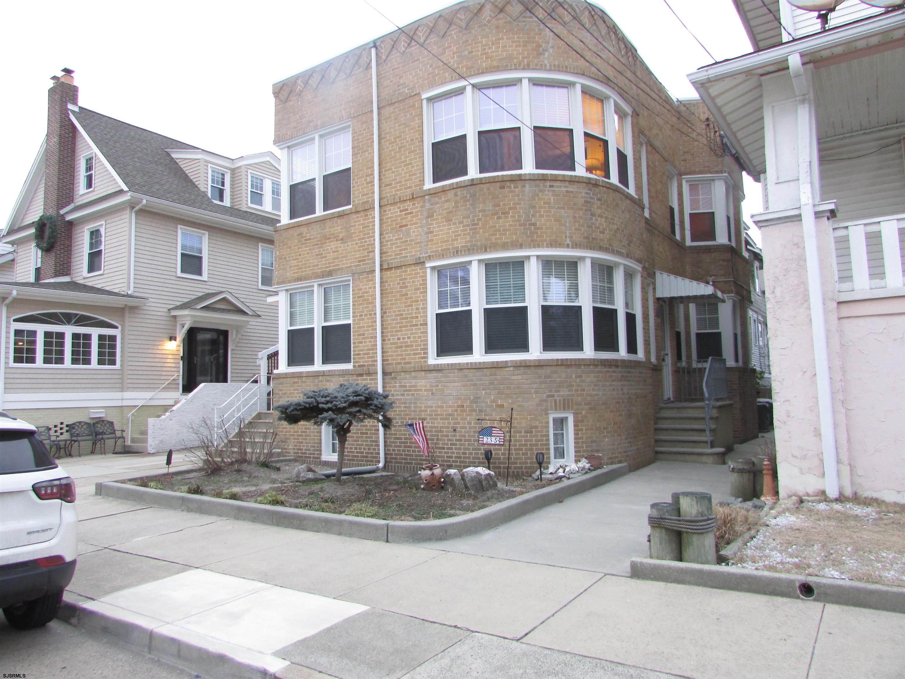 a front view of a residential apartment building with glass windows