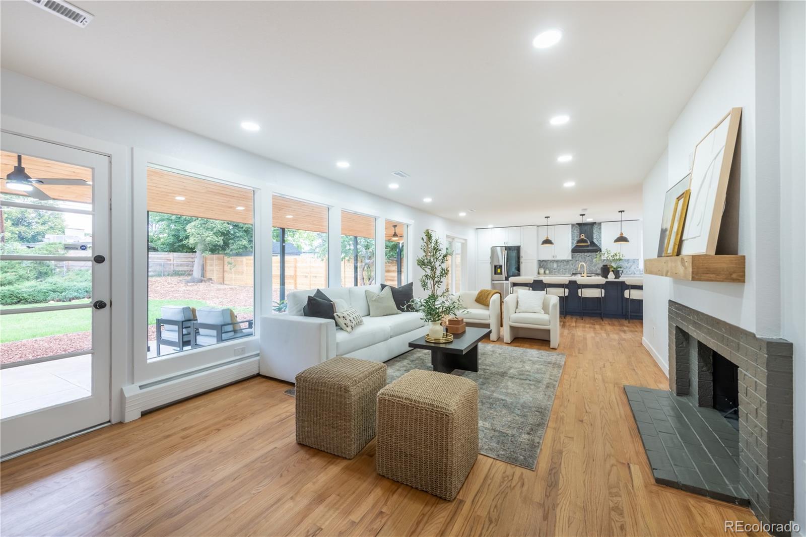 a living room with furniture wooden floor and a fireplace