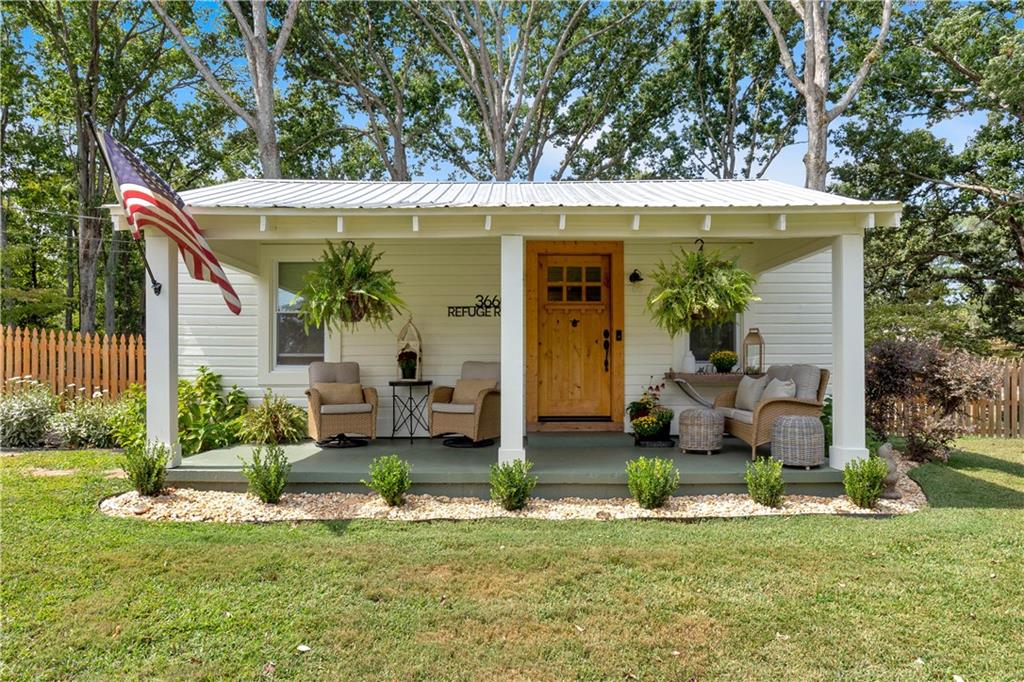 a view of a house with backyard porch and sitting area