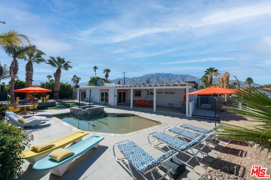 an aerial view of a house with swimming pool garden and patio