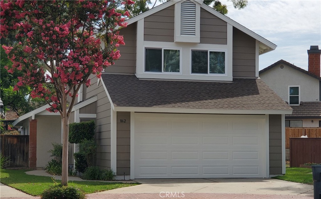 a house that has a tree in front of the house