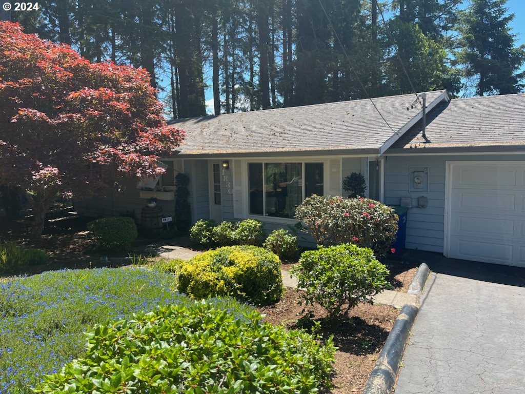 a front view of a house with a yard garage and outdoor seating