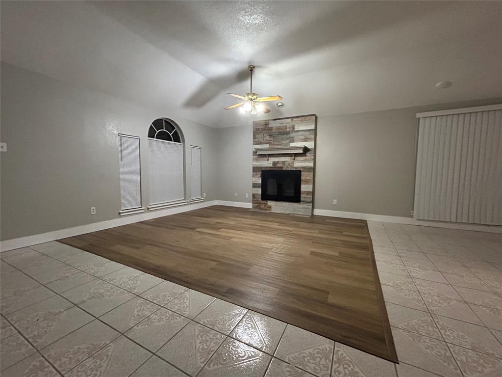 a view of empty room with a fireplace