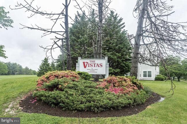 a view of a sign board and a yard