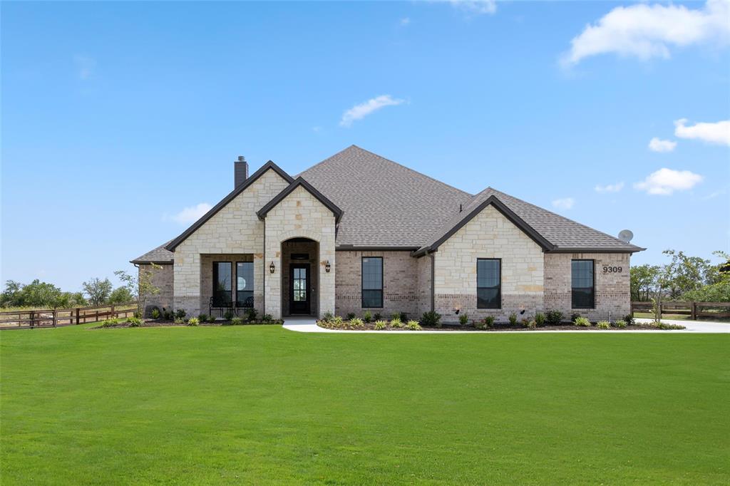 a front view of house with yard and green space