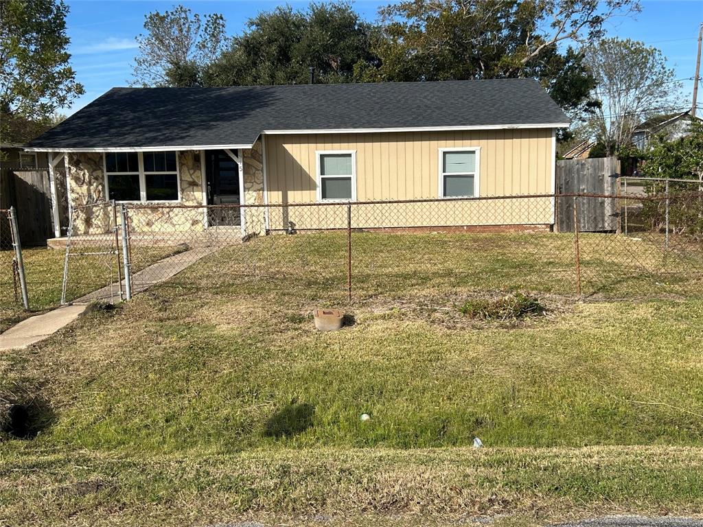 a view of house with backyard