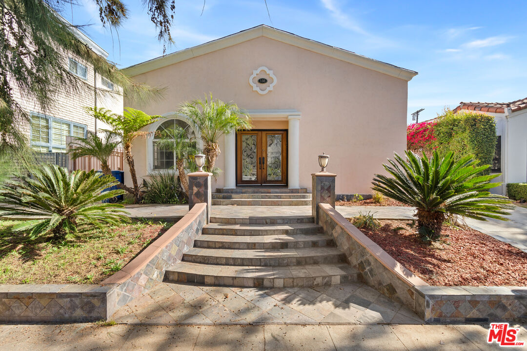 a front view of a house with garden