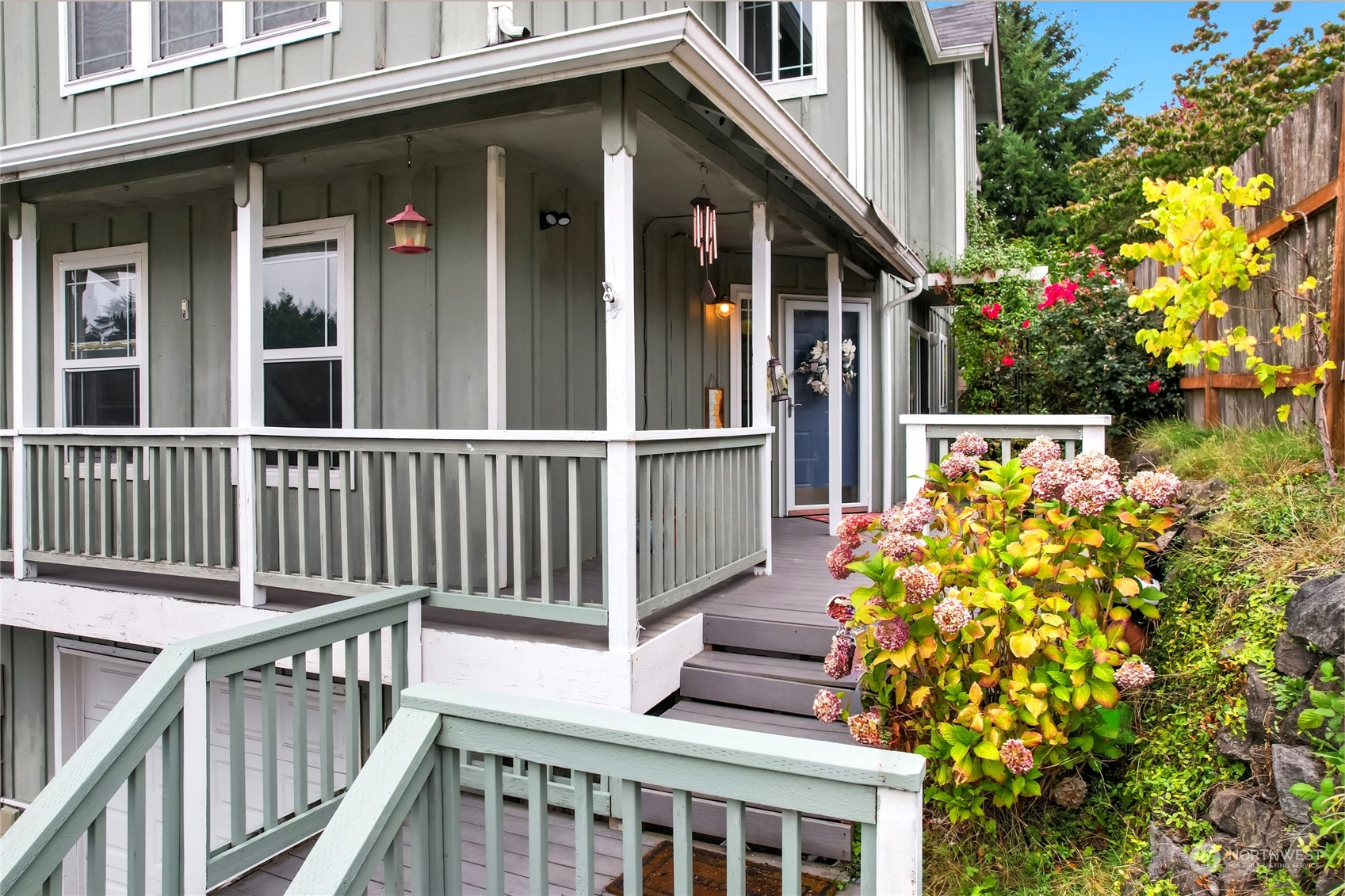 a view of a house with wooden fence