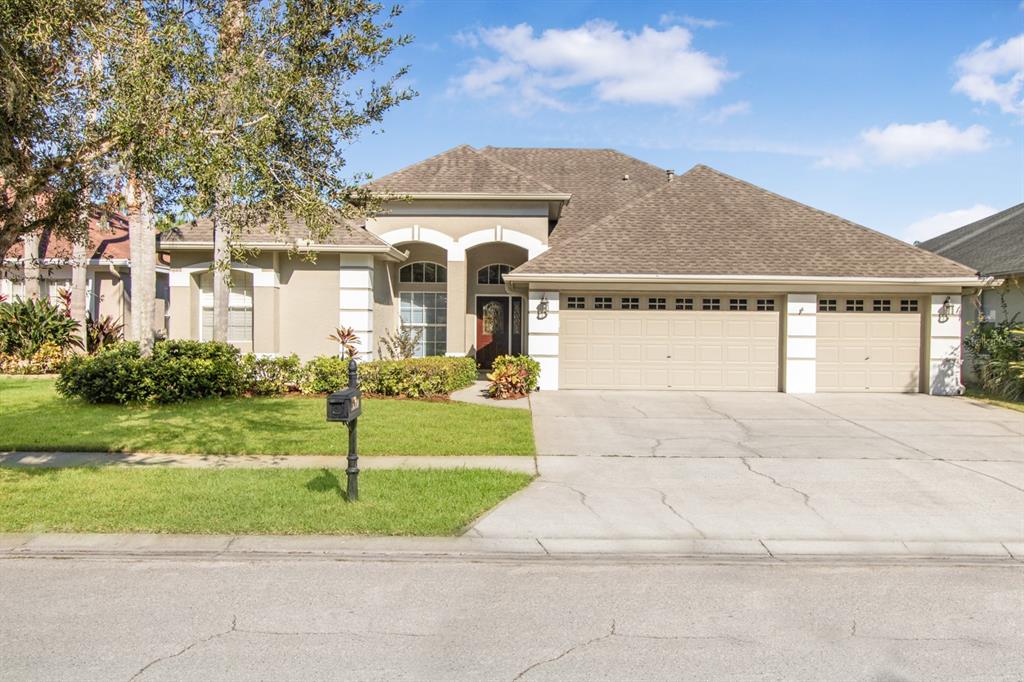 a front view of a house with a garden and yard