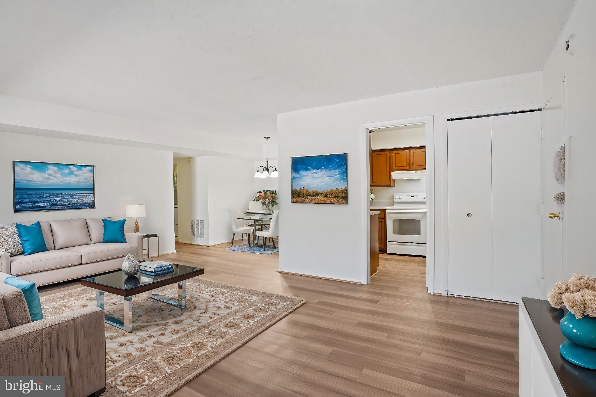 a living room with furniture and a kitchen view