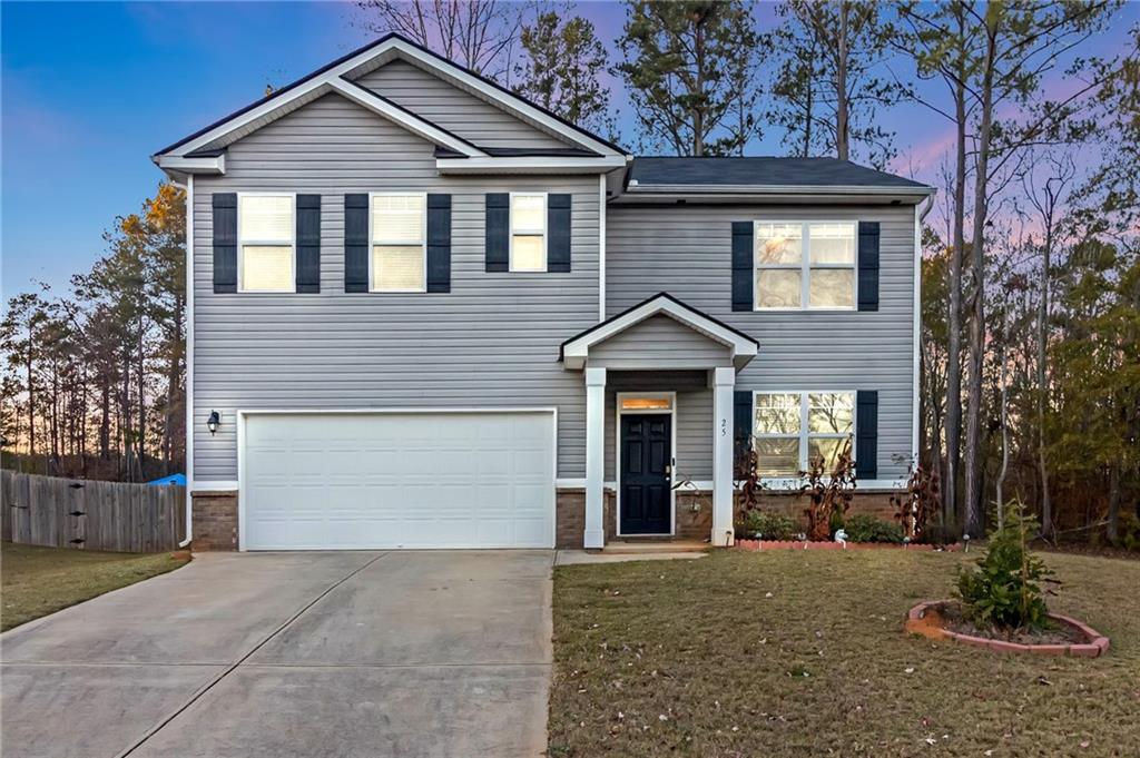 a front view of a house with a yard and garage