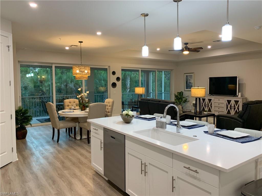 a kitchen with a sink and a large window appliances