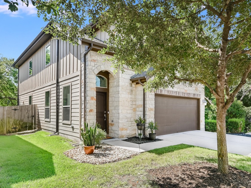 a front view of a house with a yard and garage