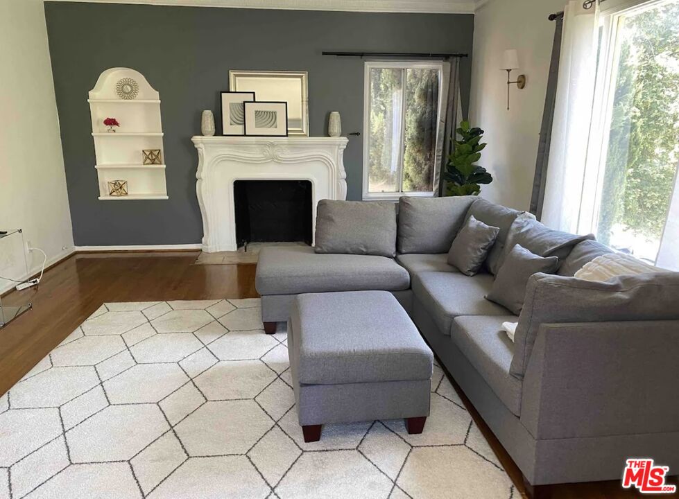 a living room with furniture and a fireplace