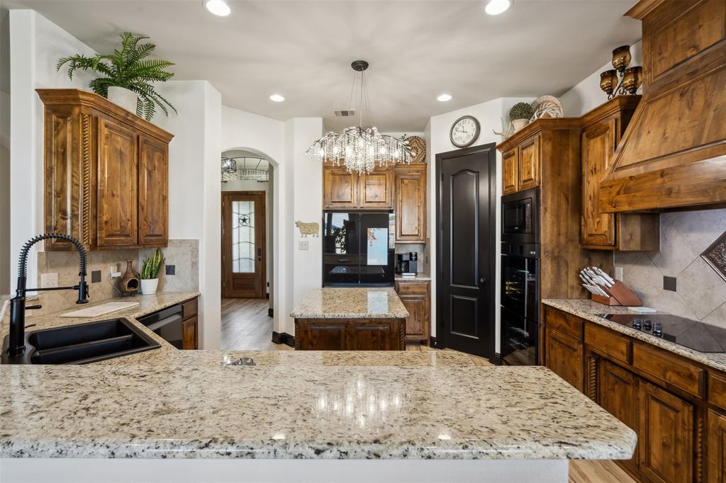 a kitchen with stainless steel appliances granite countertop sink stove and refrigerator