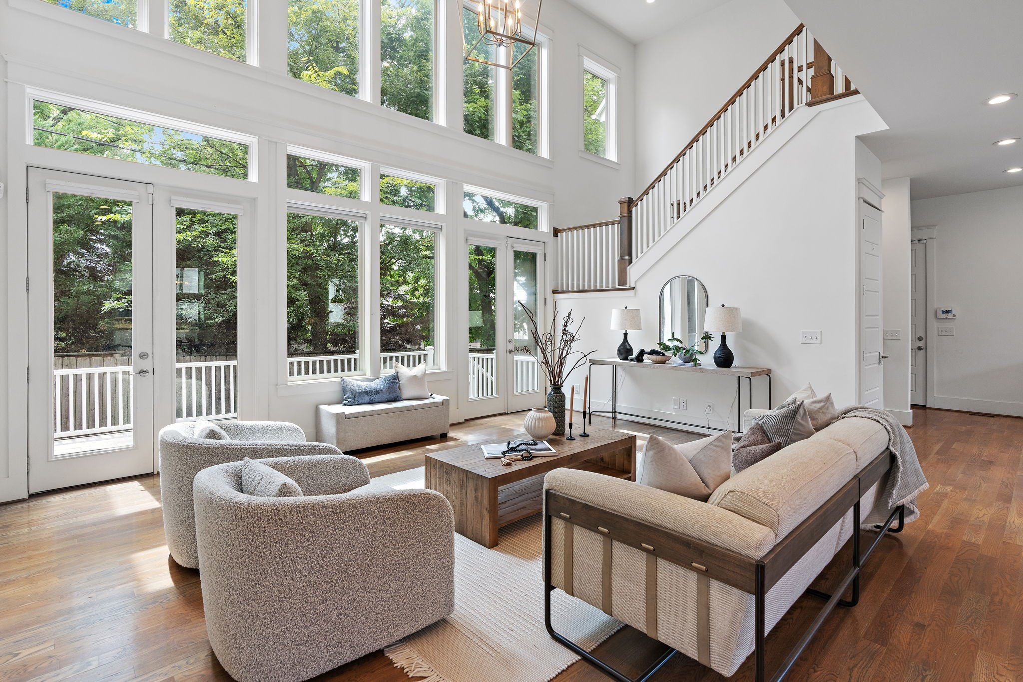 a living room with furniture and large windows