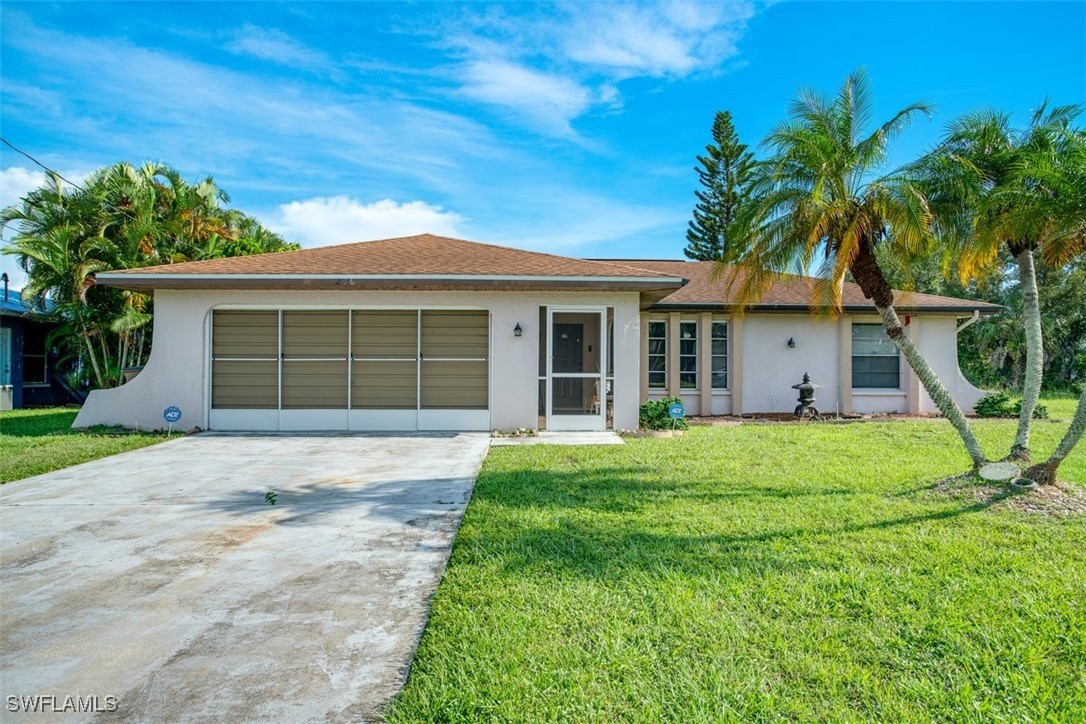 a front view of a house with a yard and garage