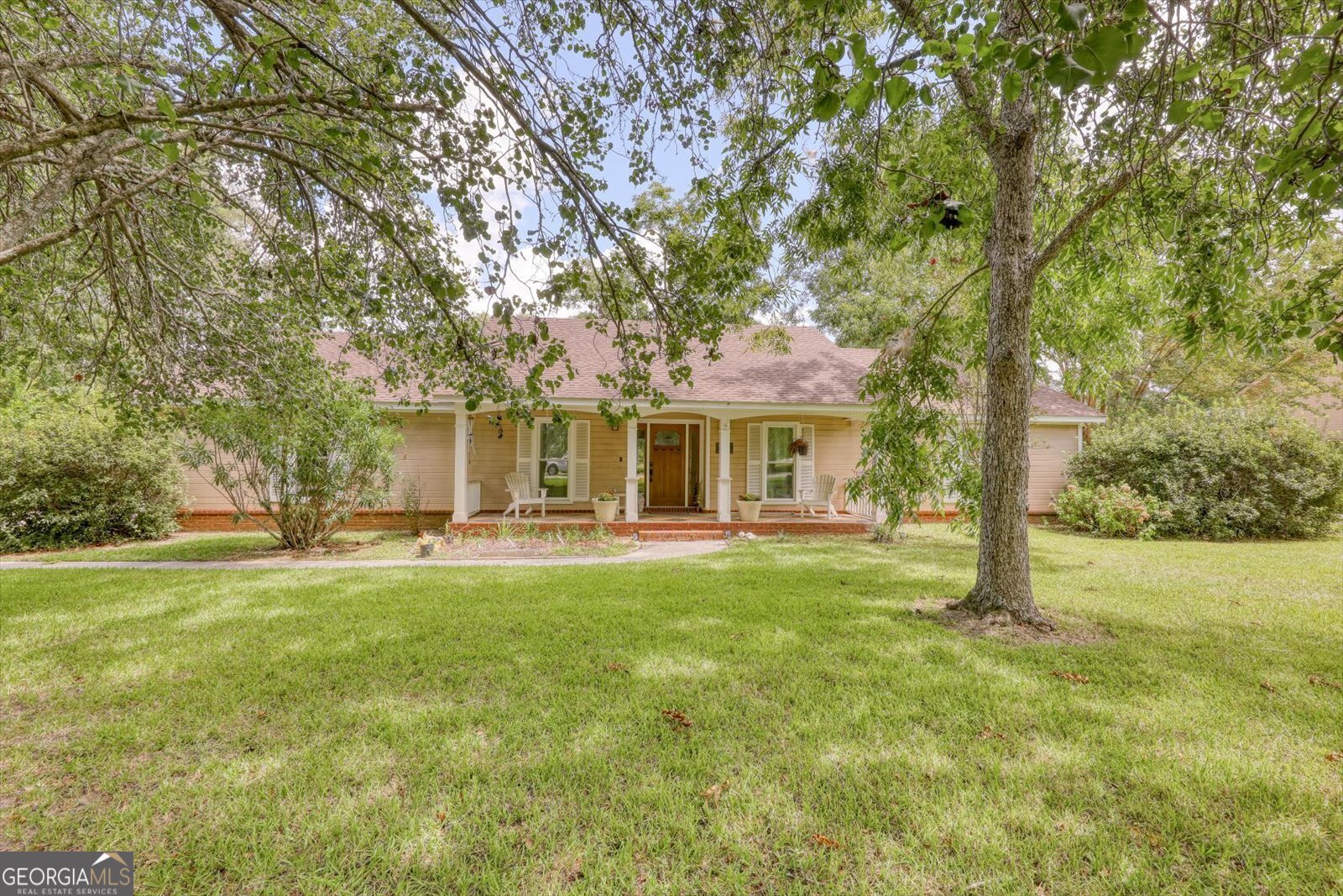 a front view of a house with a garden and porch