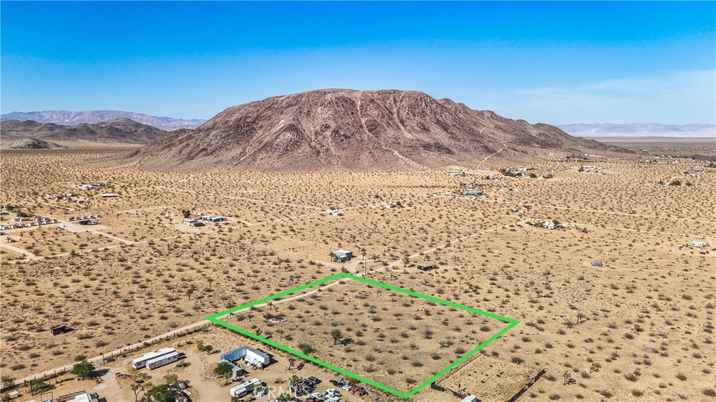 a view of a dry yard with mountain view