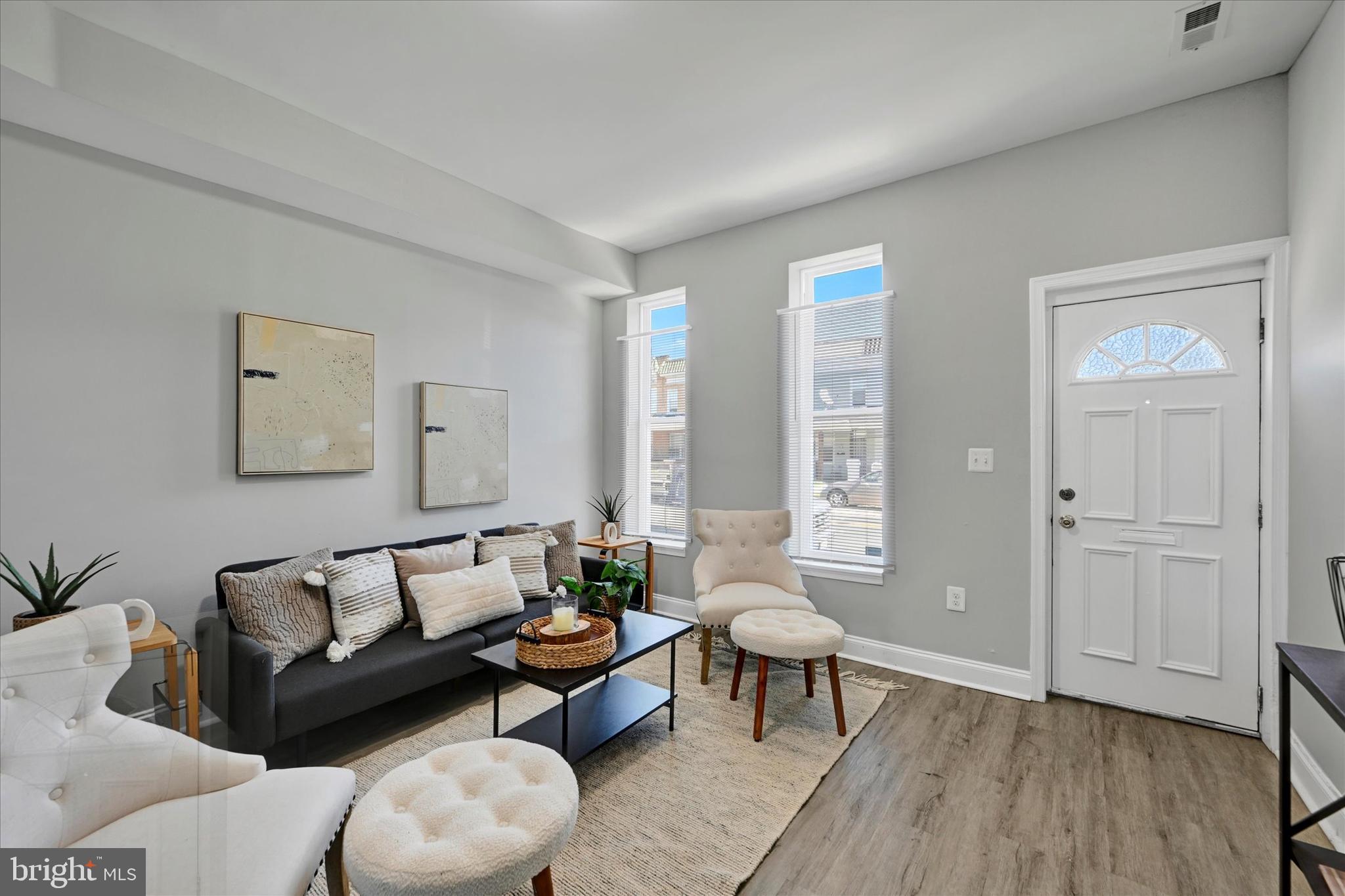 a living room with furniture and wooden floor