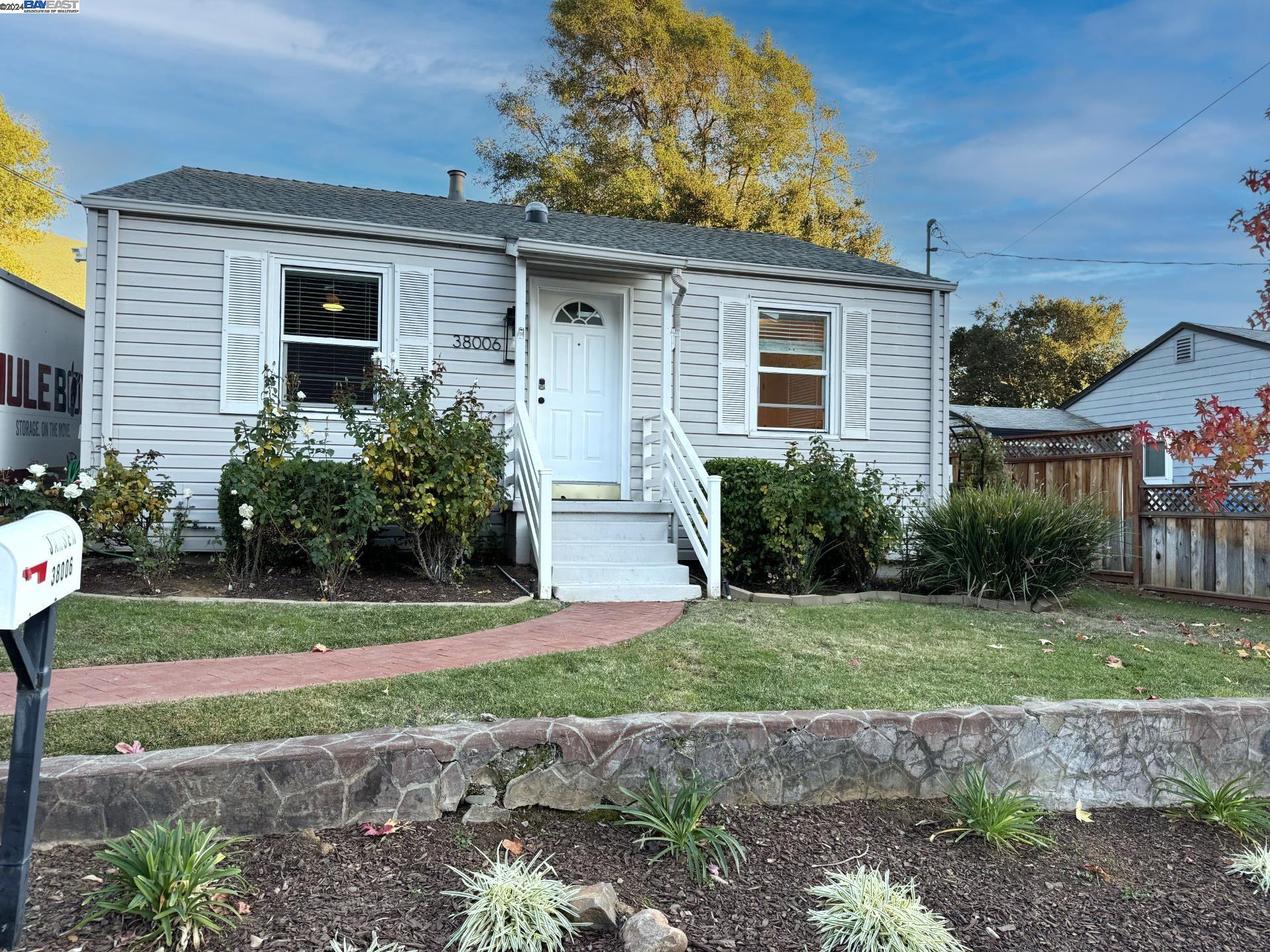 a view of a house with a yard and plants