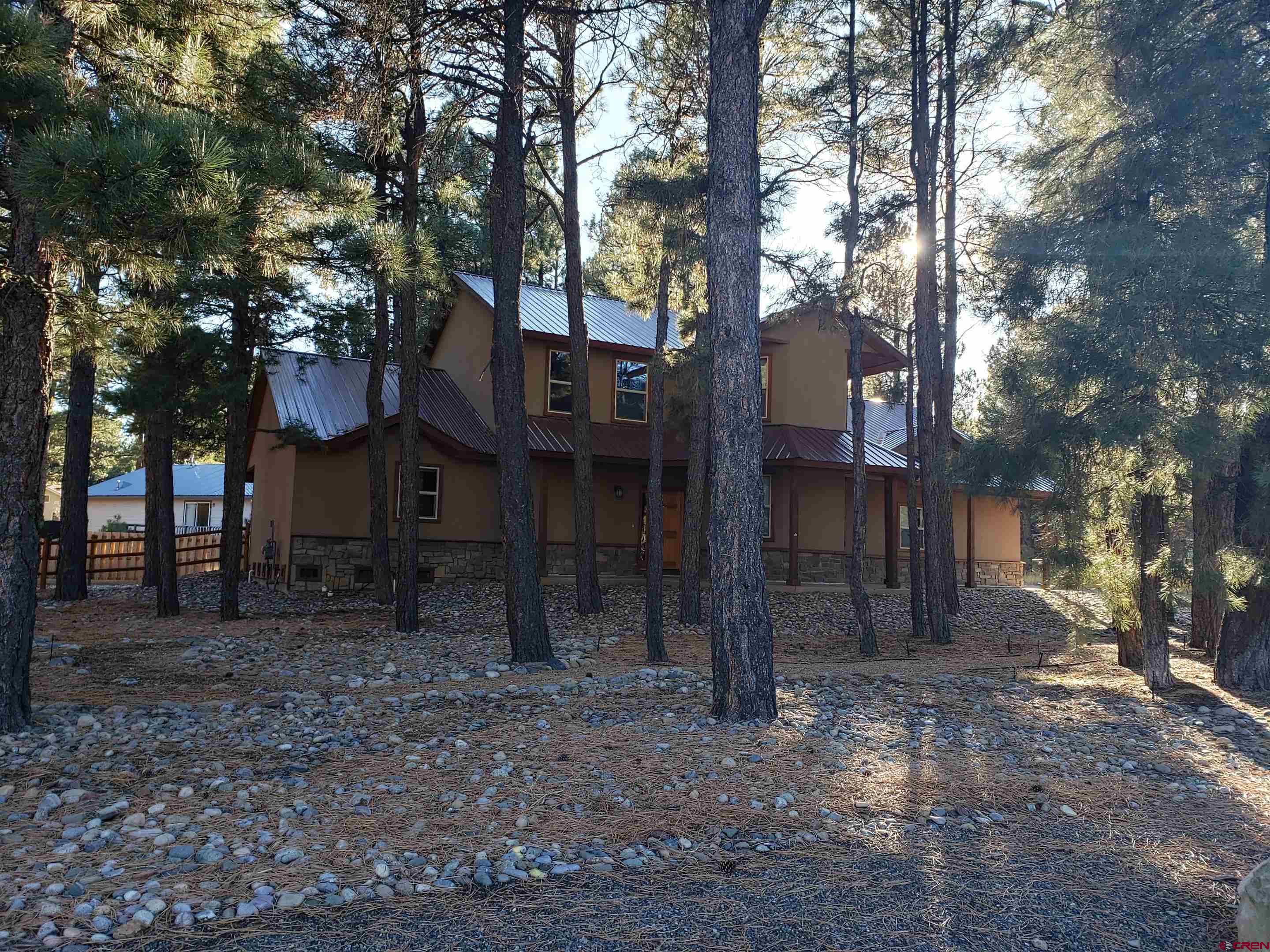 a house covered with tall trees